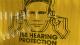 Photo of man holding fingers in his ears from the use hearing protection exhibition