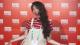 Xiaoyu Zhang in front of a red background with the Edinburgh TV Festival logo
