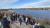 Students look out from a view point over the water. 