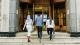 Photograph of three students walking up steps which lead into the foyer of the University of Westminster's Regent Street Campus.