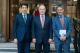 Three men: Dr Komiljon Karimov on the left, His Excellency Ambassador Ravshan Usmanov in the middle and Professor Peter Bonfield on the right stand next to each other smiling at the camera 