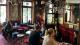 Various University of Westminster postdocs sit around tables in a pub.