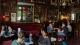 University of Westminster postdocs sat talking around various tables in a pub.