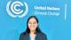 Shriya Gupta stands in front of a blue wall with white text that says United Nations Climate Change