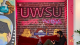 Student sitting under UWSU neon sign 