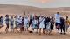 Group of students jumping in the desert.