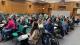 Audience listening to Sir Richard Arnold delivering his lecture in a wood-panelled room.