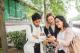 three students smiling at phone