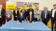 Group photo of Westminster colleagues and the delegation from WIUT renewing their academic partnership. Professor Peter Bonfield and Dr Komiljon Karimov sit at the front at a table with Uzbekistan and British flags in the centre.