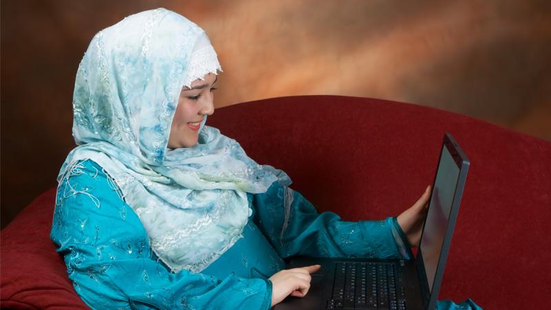 Muslim woman using a laptop