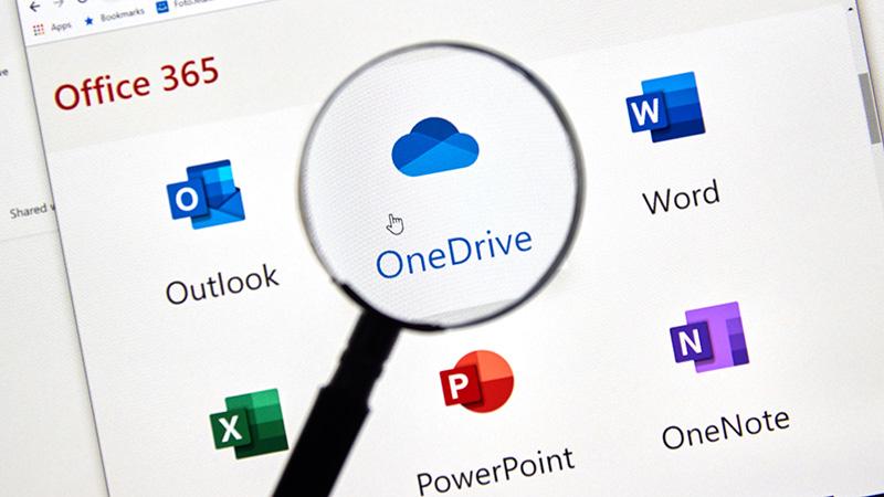 Magnifying glass highlighting OneDrive logo