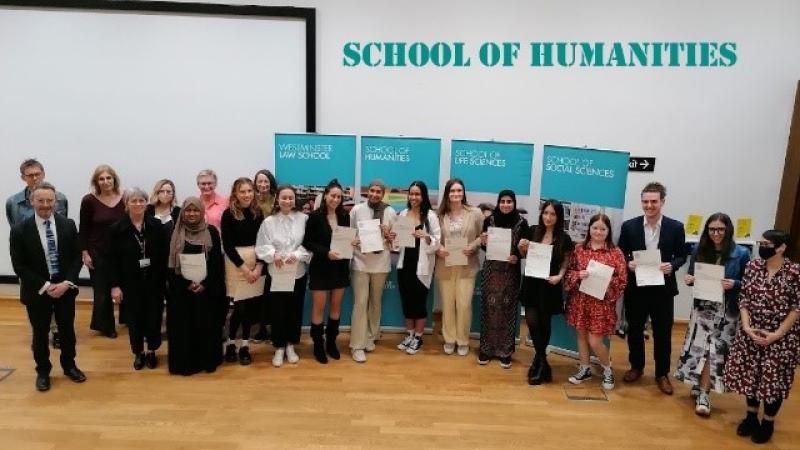 Humanities students holding up their certificates 