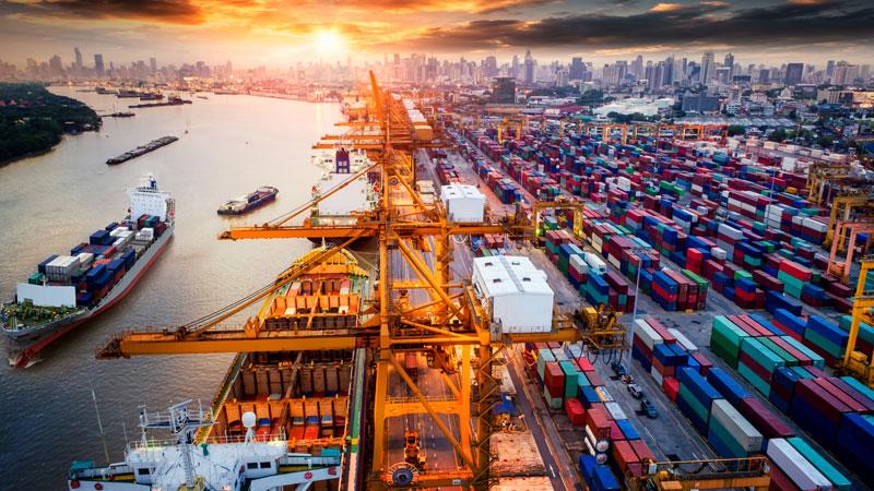 Cargo ship in shipyard surrounded by shipping containers