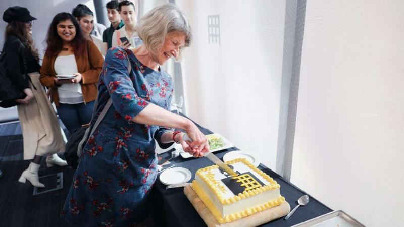 Picture of Dr Ann Rumpus cutting the Quintin Hogg Trust cake.
