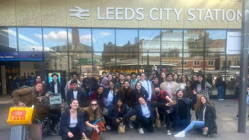 Picture of Westminster students posing for a group photo outside Leeds Central Station.
